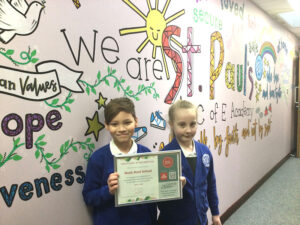 Children showing our Music Mark award certificate